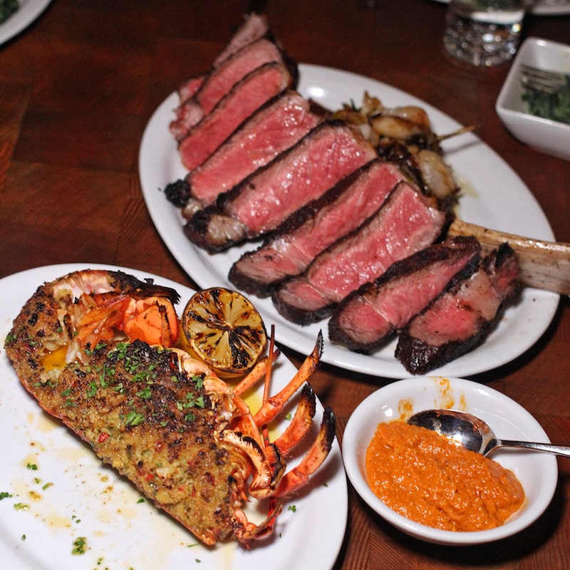 Best NYC Restaurants - Bowery Meat Co Tomahawk Ribeye and Broiled Lobster - Photo by Indulgent Eats